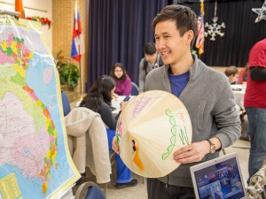 NE student Quang Nguyen explains the different parts of Vietnam on a map. Photos by Eric Rebosio/The Collegian