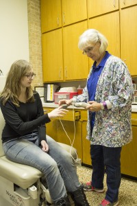 Campus nurse Susan Alvarado checks NE student Lee Ann Ducker's pulse with an oximeter. Photo by Katelyn Townsend/The Collegian