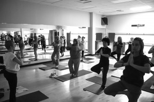 Faculty and staff practice a tree pose during a yoga class, part of SE’s wellness program.  Photo by: Bogdan Sierra Miranda/The Collegian