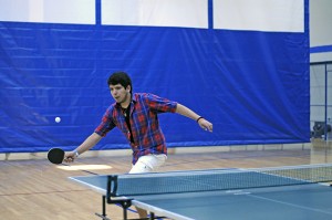 Roberto Aparicio reaches for a shot to his right in his first match of the NE pingpong tournament March 25. The pingpong club scheduled two more tournaments April 8 and 22.
