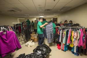 TR volunteers sort clothing at One Safe Place, where women can find items to wear for employment interviews. This was one of four places where students served March 21.
