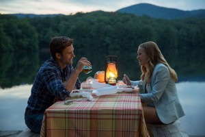Scott Eastwood and Britt Robertson sit at a table in The Longest Ride. The film is based on a Nicholas Sparks book. Photo courtesy Warner Bros.