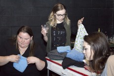 Nicole Sephard and Sarah Dirskill fold laundry while Morgan Mizell drinks during the one-act play Laundry and Bourbon.Photos by Bogdan Sierra Miranda/The Collegian