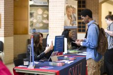 SE student Van Smith Jr. stops by the SMU table to discuss transfer opportunities at Grad Fest April 21.Hayden Posey/The Collegian
