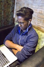 NE student Ravi Pooran finds that listening to music helps him enjoy doing his homework. Music stimulates the brain and brings people certain emotions at different times. Kaylee Jensen/The Collegian