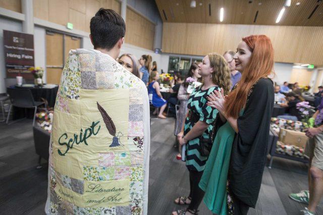 South student Amanda Fralicks, right, talks with faculty editor Logen Cure bundled in a quilt. The quilt was used on the cover of the 30th anniversary issue of Script.
Photos by Peter Matthews/The Collegian