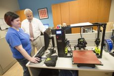 NE library specialist Brooke Thompson and drafting adjunct instructor Jeffrey Opel prepare to create an item on the 3-D printer. Opel teaches an introduction to 3-D printing software class.Photos by Peter Matthews/The Collegian