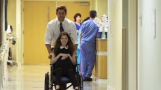 John Hollar (John Krasinski) wheels Rebecca (Anna Kendrick) through a hospital. The Hollars, a dramatic comedy, is Krasinski’s directorial debut. Courtesy of Sycamore Pictures 