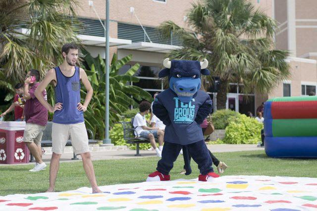 SE student Zach Lents begins a game of twister against TCCs mascot Toro.  Photo by Hayden Posey/The Collegian