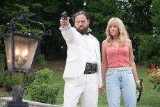 Zach Galifianakis points a gun as his partner in crime Kristen Wiig watches in Masterminds. Photo courtesy Armored Car Productions