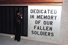 A visitor looks at the names listed on the war memorial on NW Campus. Students can buy dog tags to help support it. Collegian file photo