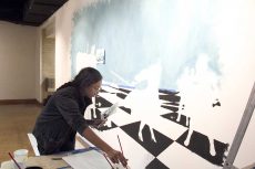 NW student Humna Raza paints her piece, What’s Your Next Move? The art features human shapes fighting. Her message was about critical life choices. Photos by Luis Hernandez Jr./The Collegian