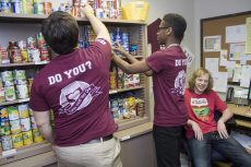 NE volunteers arrange the shelves at the campus food pantry in NCAB 1136. Students run the pantry to help feed students. Collegian file photo