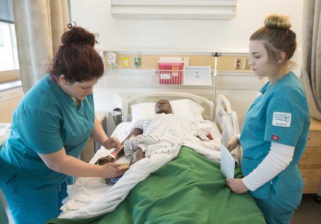 Nursing student Hannah Hodges practices injection administration on a manikin while student Addie Hindman observes in the Practical Skills Lab on Trinity River East Campus. The students are taking the Foundations of Nursing class. 

Photos by Peter Matthews/The Collegian
