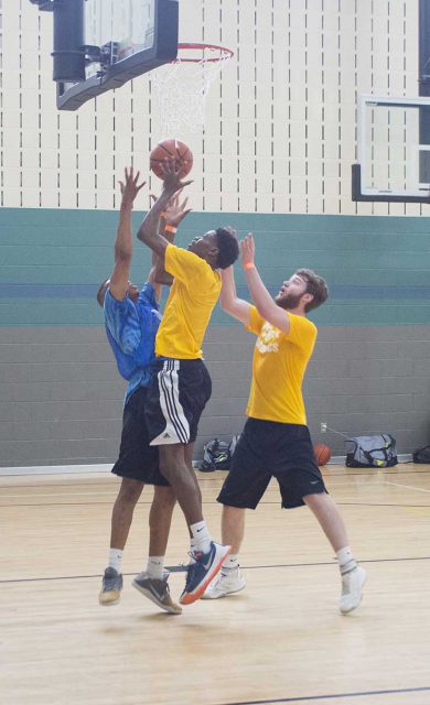 Clint Otwori jumps to make a basket. Otwori scored 23 points in the first game and helped lead his team to win the SE Campus basketball tournament.