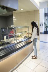 Texas Association of Private and Parochial Schools student Daniela Palacios chooses what she wants to create her pasta at the action pasta section.