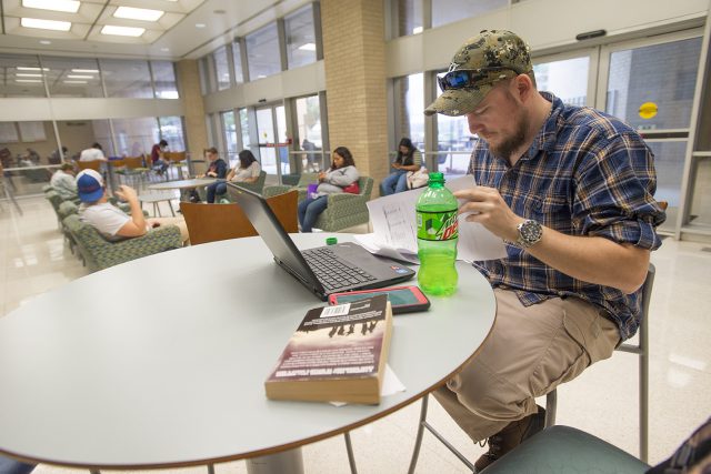 NW student Collin Hart reviews the syllabus for his sociology class in WTLO while waiting to head to his next class.