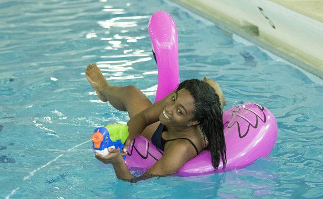 Chonte Turner uses a water gun to soak students during the Intramural Pool Party Aug. 31 on South Campus.