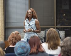 Winner Bessie Banks reads her poem "Quit Stepping on My Heart" at the Under the Clock Tower event Sept. 20.