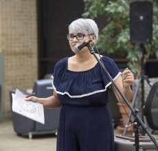 English associate professor Rebecca Balcarcel introduces contributors to the NE English Department's literary journal "Under the Clock Tower" at the reading and reception Sept. 20 on NE Campus. Eleven of the published winners read their fiction, non-ficiton and poetry works at the event.
