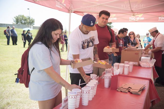 NW students Kayla Martinez, David Tapia and Juan Meza pick up free lunches, including hamburgers and drinks provided by In-N-Out for Northwest Fest Sept. 7.