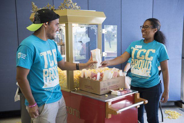 NW student Daniel Sanchez picks up popcorn from student activities team member Devin Reaux during Northwest Fest, a back-to-school event for NW students Sept. 7.
