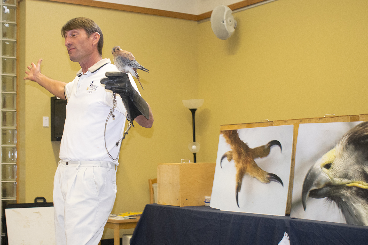Blackland Prairie Raptor Center executive director Erich Neupert holds Orville the American kestrel at a lecture on SE Campus Sept. 5.