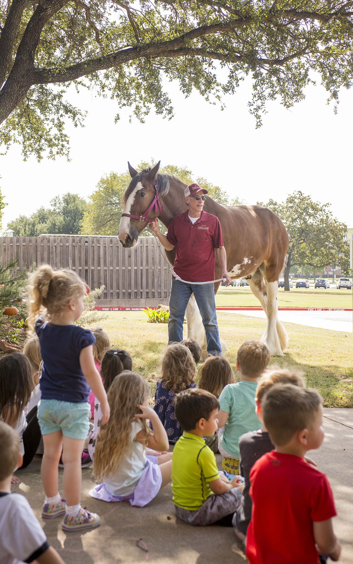 Robert Early tells children from the Children’s Center about Hamish, a 6-year-old Clydesdale that was on NE Campus Oct. 13. The 2,000-pound horse was filmed for a video in various locations around the campus before children got to hang out with him.