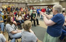 TR student Cheyenne Warren (seated, left) interprets as Alice Turner (right, in blue) uses sign language to tell students about her life as a blind and deaf person.