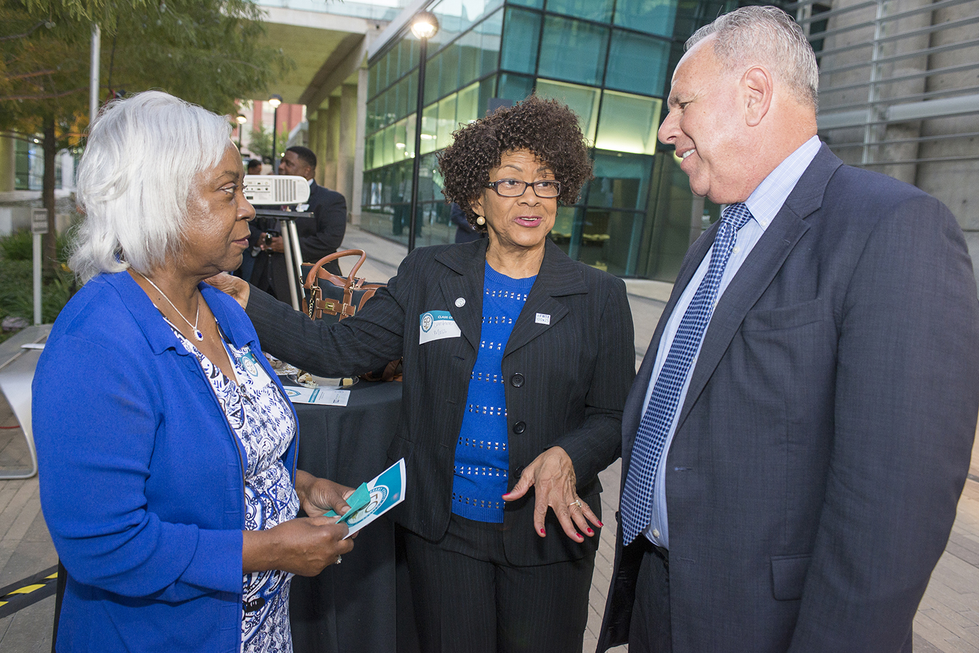 Chancellor Eugene Giovannini speaks with two former nursing students, Glenda Sturges (left) and Christine Moss (center), from the program’s first class during the program’s golden anniversary celebration Oct. 12 on TR East Campus.