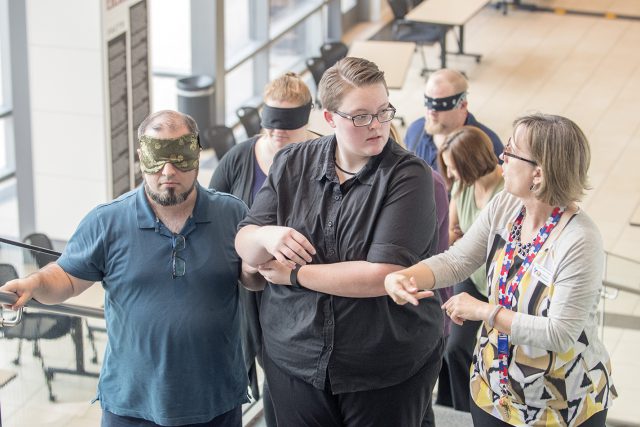 James Myers, shown at left with Rachel Alsip and sign language interpreting coordinator Sammie Sheppard, used a blindfold and earplugs to simulate being blind and deaf.
