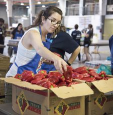 NW art professor Trish Igo goes through a box of red bell peppers at the NW Community Food Market Sept. 15.