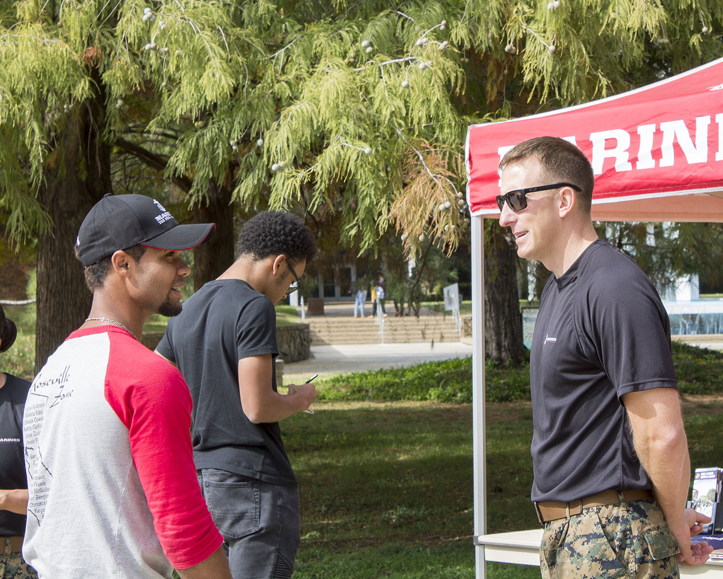Recruiter Chase Smith talks about the benefits of joining the U.S. Marine Corps with Jesse Smith at the Armed Forces’ Birthday on South Campus Nov. 6.