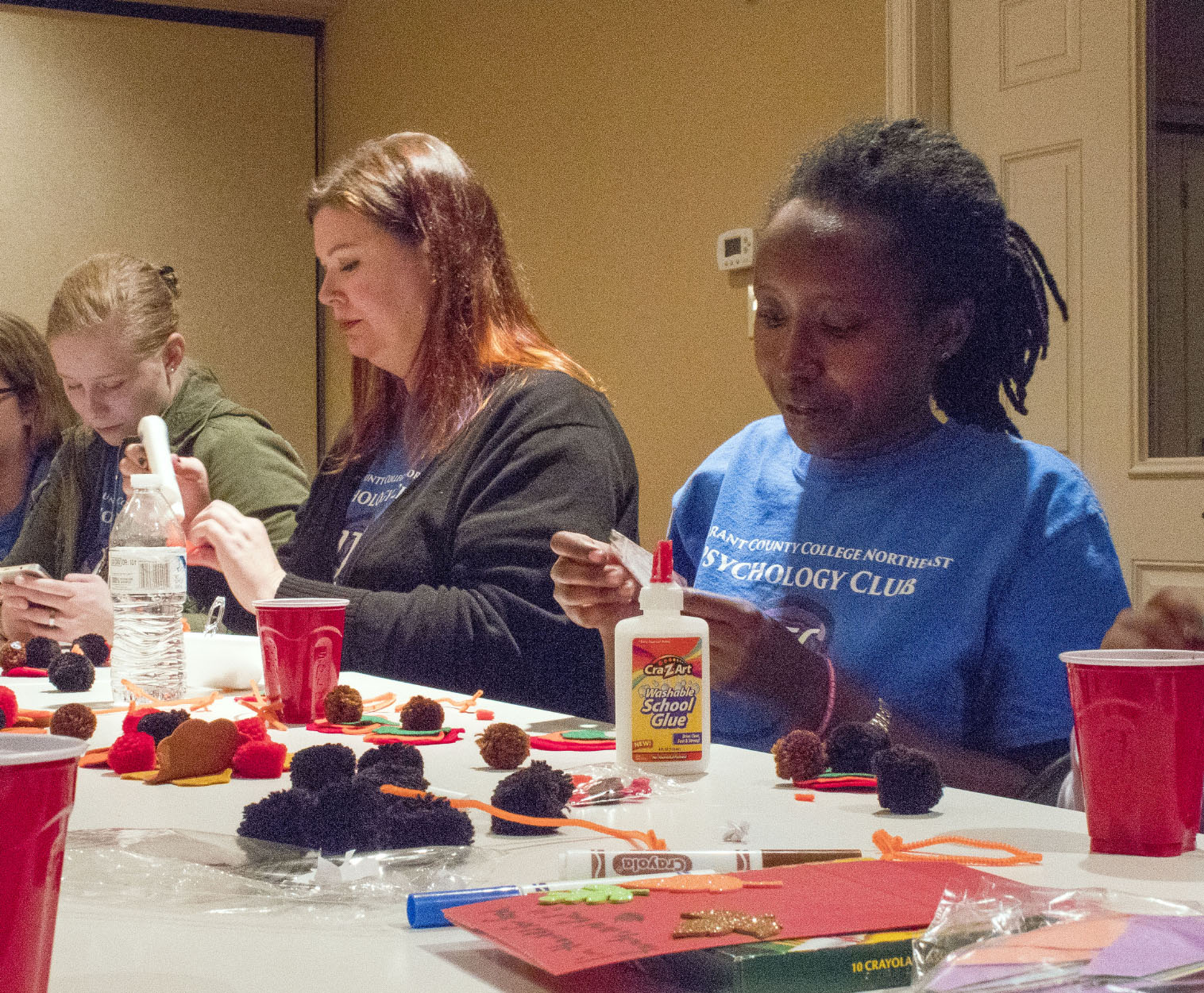 NE students Elizabeth Harris, Molly Wright and Alice Muhindura volunteer with the Psi Beta and Psychology Club at an after-school program with local children Nov. 10 in North Richland Hills.