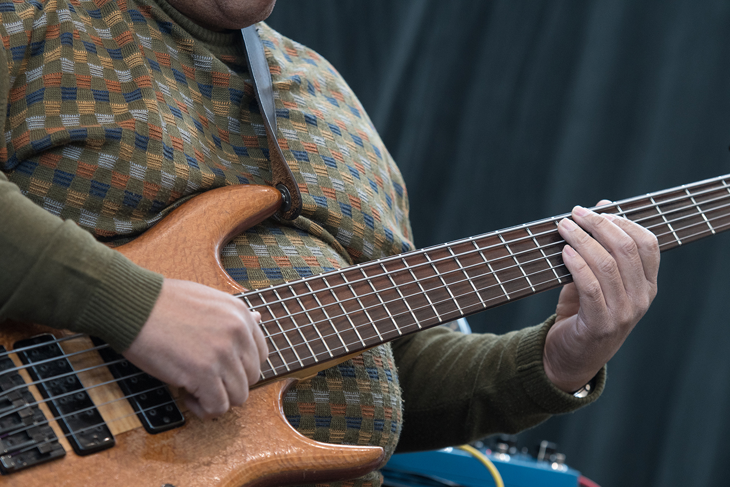Walter Nelson strums his bass guitar while performing with his group Linny Nance & Network on TR Campus Feb. 13.