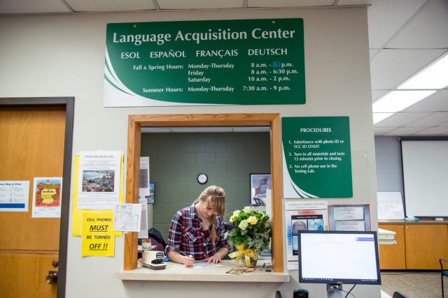 German tutor Christina Clarke completes paperwork at the NE Language Acquisition Center located in NACB 1114.