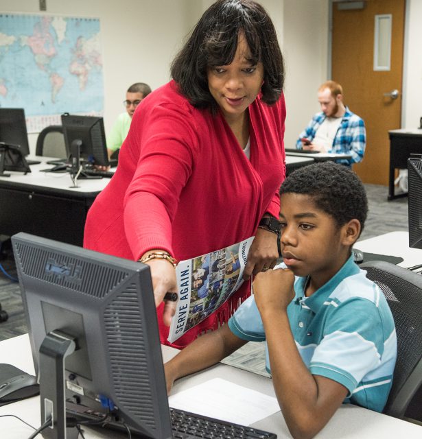 SE instructor Katrina Brown aids coding student Xabe Cole with an assignment in the Python coding class on SE Campus.