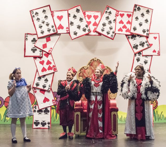 SE students Leo Vibal and Paige Sommer (the King and Queen of Hearts) surprise Sadie Taylor (Alice) during rehearsal of Alice in Wonderland March 30.