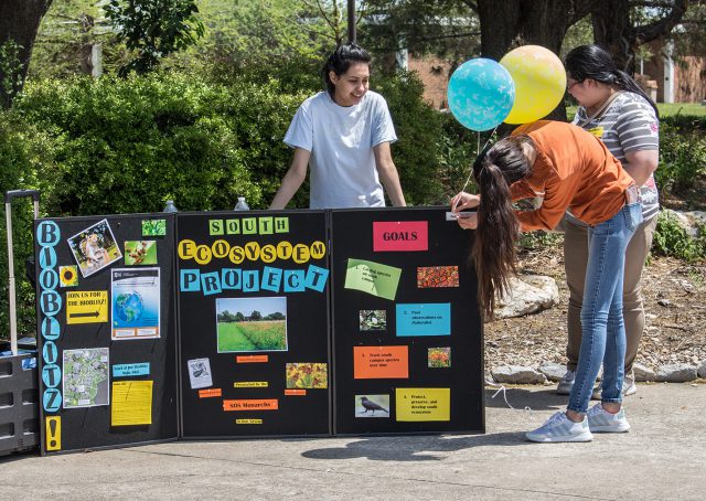 South students Salma Cordoba, Leslie Villegas and Jenny Ruiz inform others about the ecosystem project at the Earth Day celebration April 18.