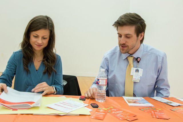 Registered dietitian Jeri Bright and physician Tim Dobin look over information during the health expo on South. Medical professionals were on hand to give health advice.