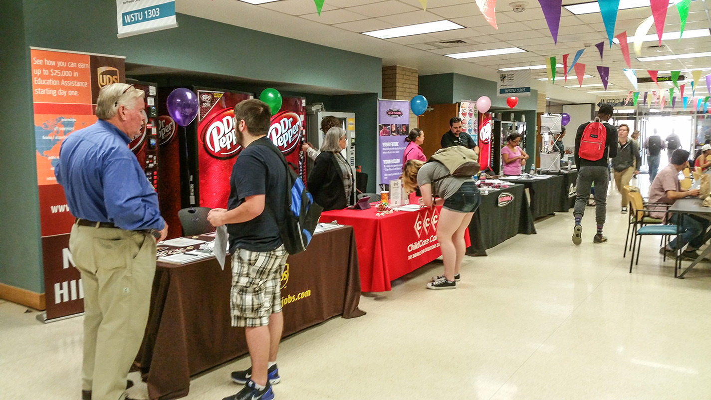 Students talk to employers to find out more about job opportunities at a 2015 job fair on NW Campus. The Cinco de Mayo Job Fair will be held from 10 a.m.-2 p.m. May 2 in WSTU 1303 and 1305 and will feature over 40 employers.