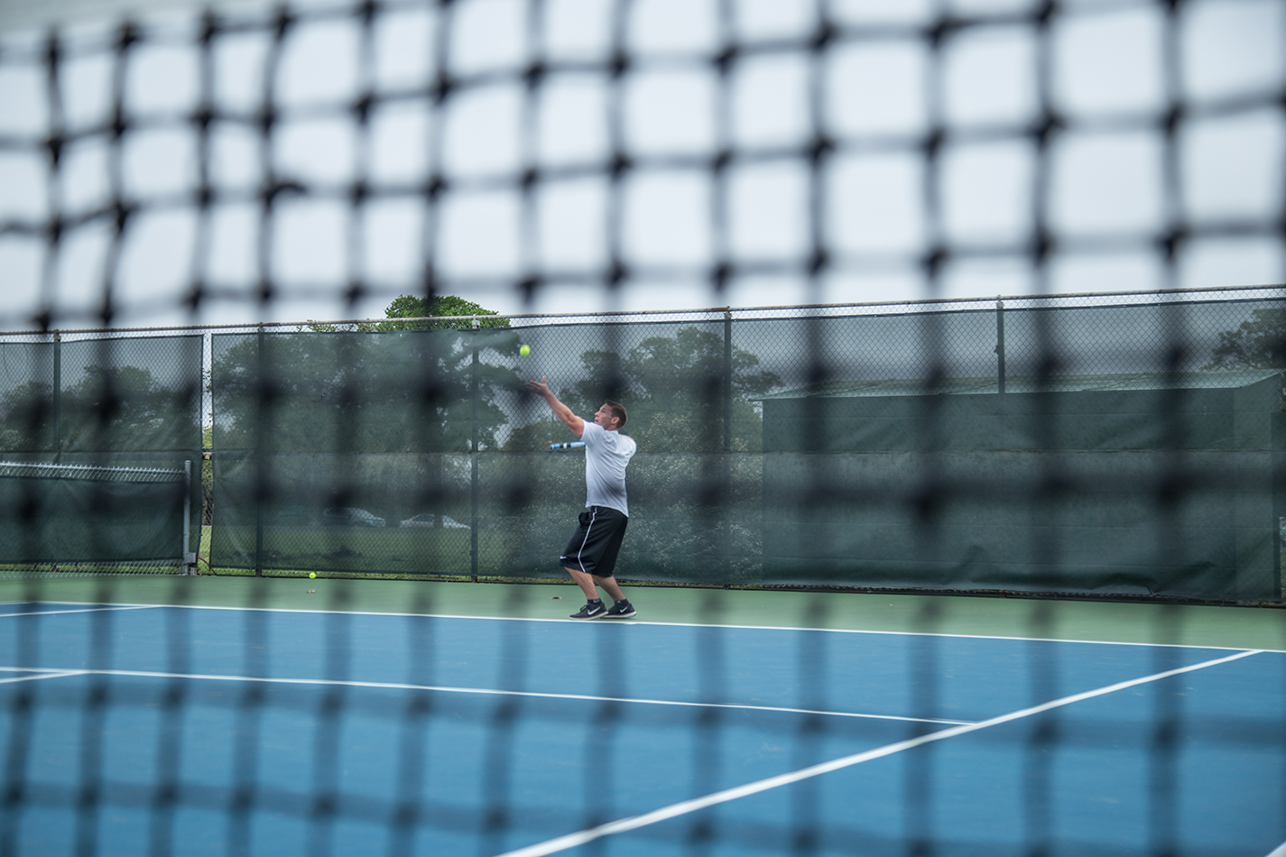 NE student David Schwartz serves during practice before the NE Tennis Club travels to the Tennis On Campus National Championship.