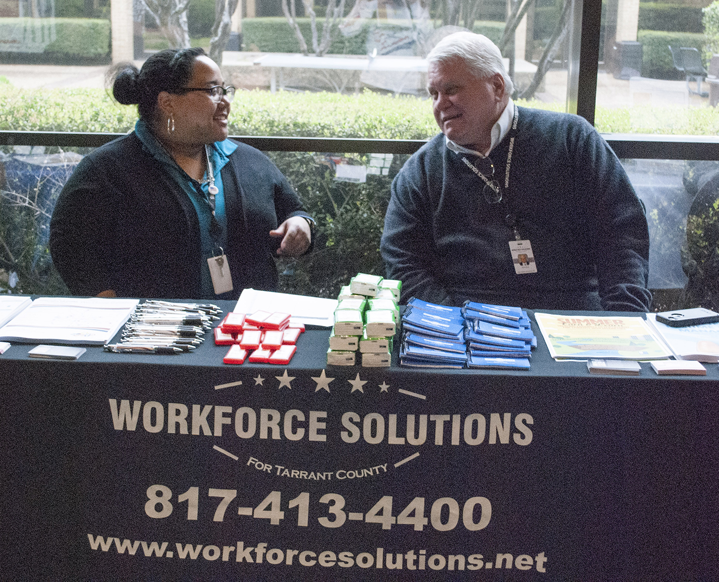 Tarrant County Workforce Solutions recruiters Meredyth Kelly and Jerry Krus discuss students as prospective employees at the districtwide job fair March 28 on NE Campus.
