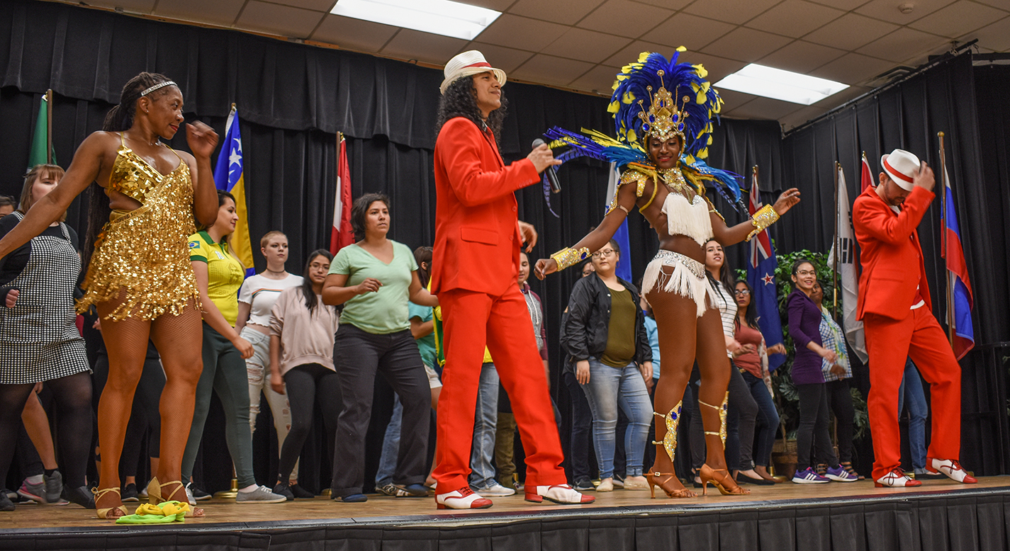 United Dance Academy of Dallas performers bring students and faculty on stage to dance with them during their Rio de Janeiro-style Brazilian samba performance April 9 on NE Campus.