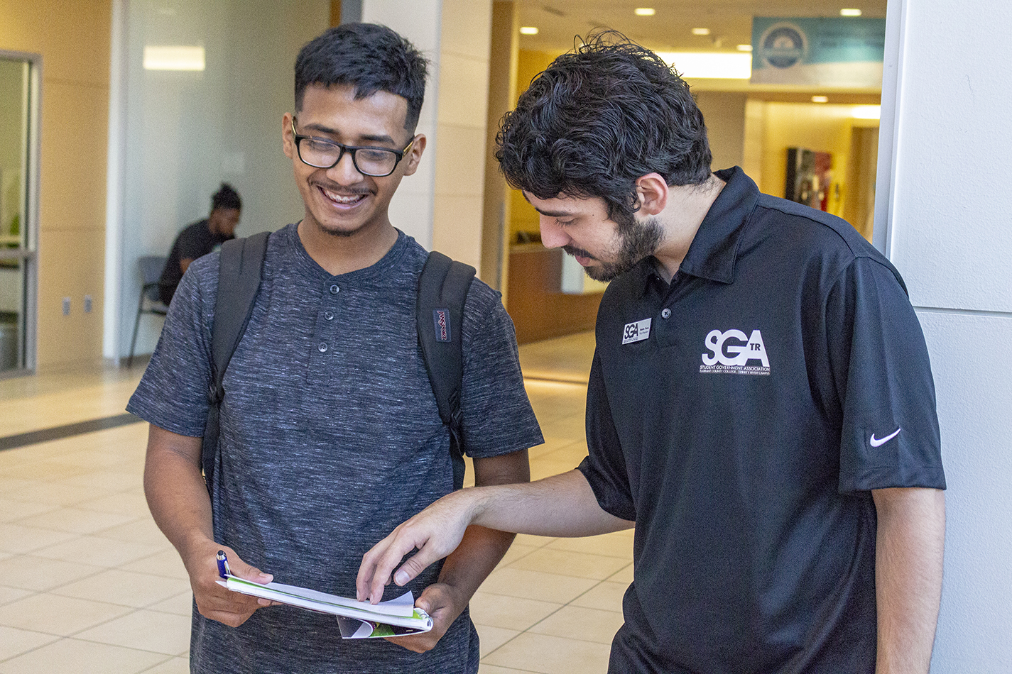 TR SGA vice president Dakota Flors helps first-year student Mario Mora with locations on the TR Campus map.