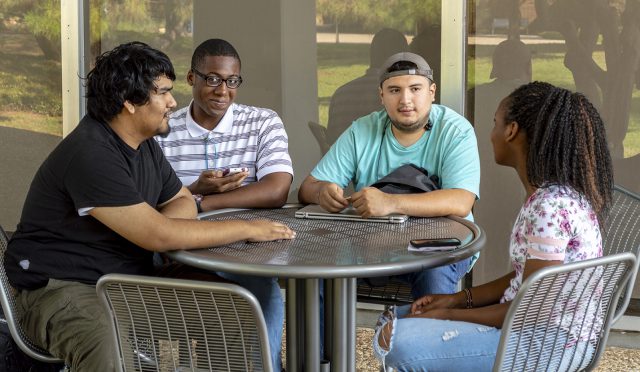 A group of South students hang out outside of the Jenkins Garrett Library on South Campus while waiting for their next classes to begin on the first day of the semester Aug. 20.