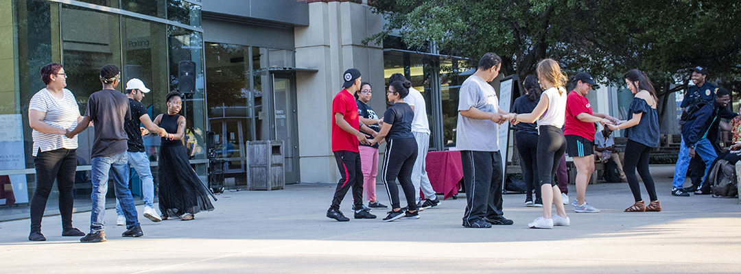 TR students practice steps to the bachata they learned during TR’s Noche de Salsa event Sept. 19 in the campus courtyard. Students also learned to salsa during the Hispanic Heritage Month event.