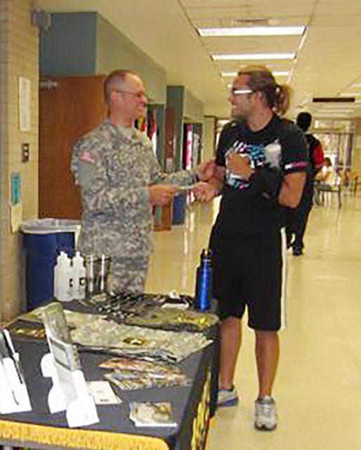 A+recruiter+offers+a+student+information+about+military+careers+at+a+previous+fair.