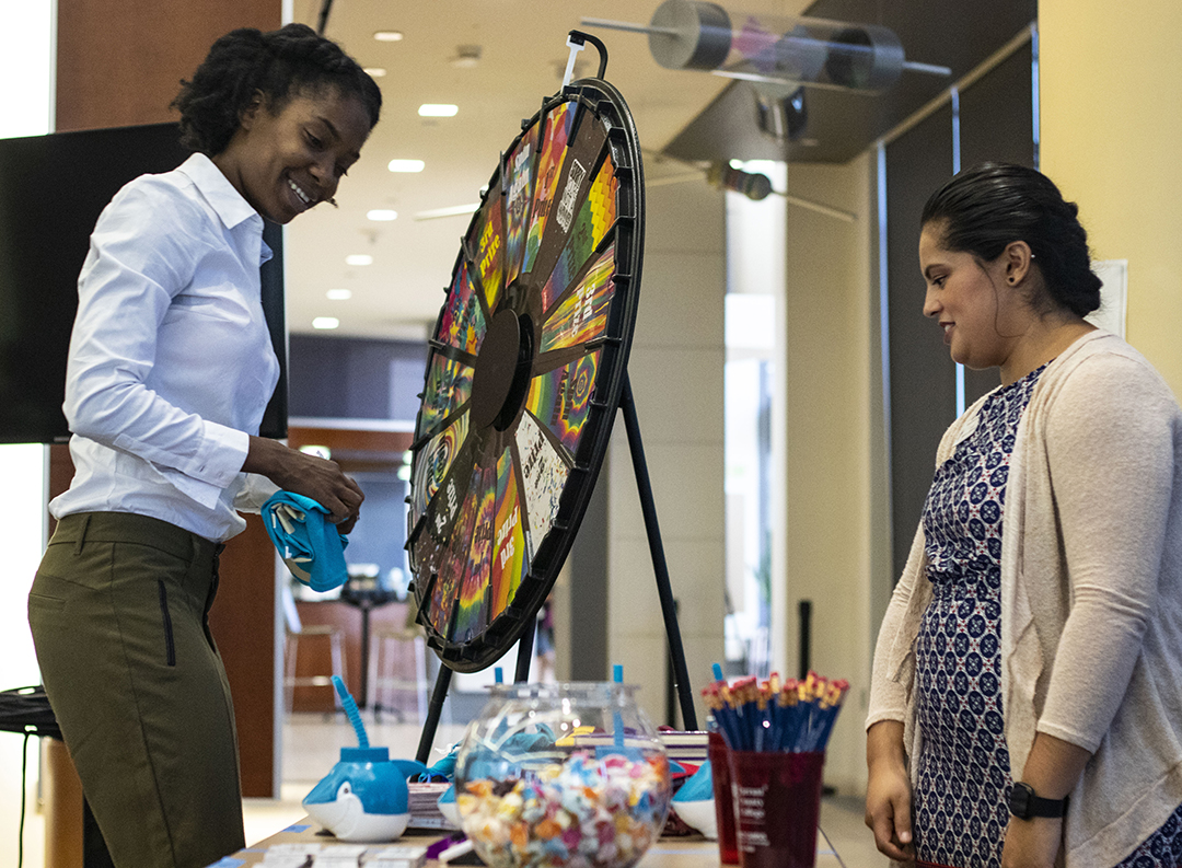 TR student O’Dasha Lewis claims her prize after spinning the wheel with the Student Worker Fair lead coordinator Jesica Valadez.
