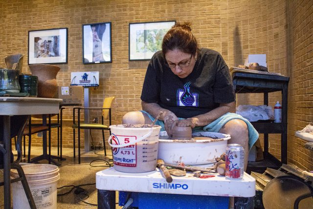 NW and NE student Alison Cohen shapes clay at Club Rush on NE Campus. Cohen is a member of the NE Campus Association of Potters and Sculptors.